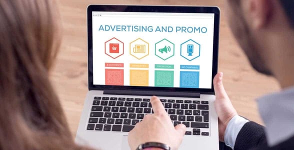Photo of people looking at online ads