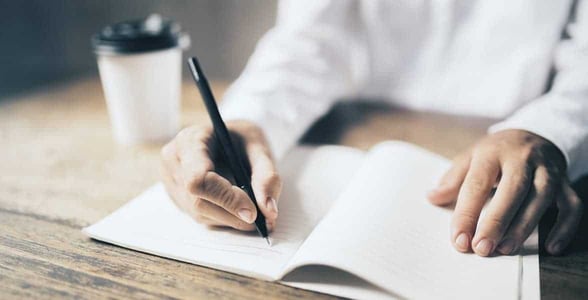 Photo of a man writing