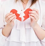Photo of someone holding a ripped heart