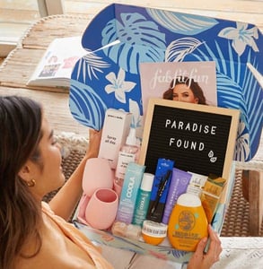 Photo of a woman opening a FabFitFun box Photo of a woman opening a FabFitFun box