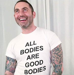 Photo of Dr. Chris in a body-positive shirt Photo of Dr. Chris in a body-positive shirt
