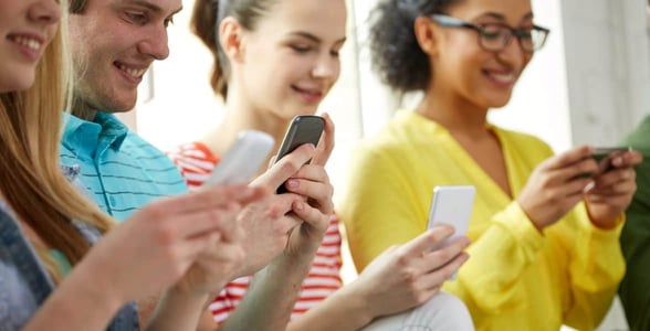 Photo of young people on their phones