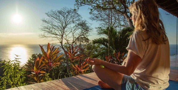 Photo of a woman doing yoga at sunset