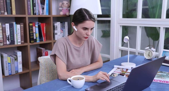 Photo of woman using Timekettle device Photo of woman using Timekettle device