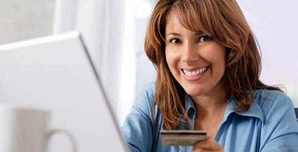 Photo of a woman paying for online services Photo of a woman paying for online services