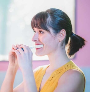 Photo of a woman using Y-Brush Photo of a woman using Y-Brush