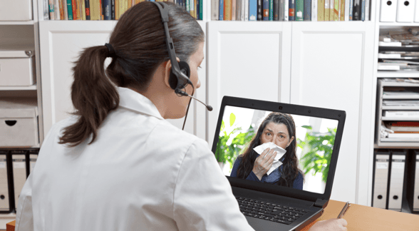 doctor on video call with woman doctor on video call with woman