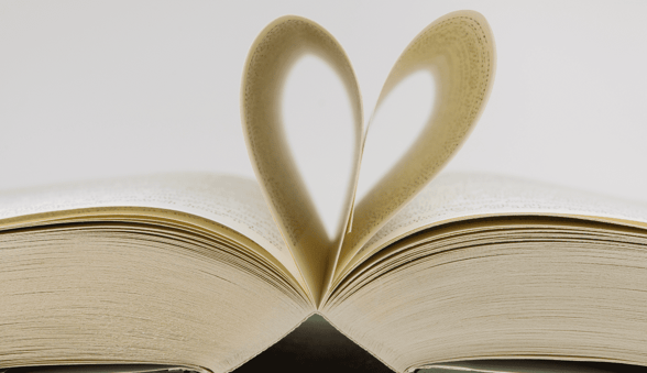book with pages bent into heart