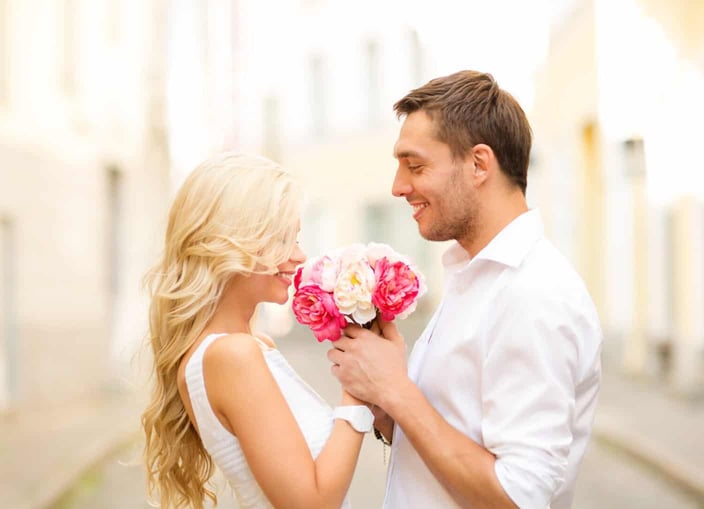 summer holidays, love, relationship and dating concept - couple with bouquet of flowers in the city summer holidays, love, relationship and dating concept - couple with bouquet of flowers in the city