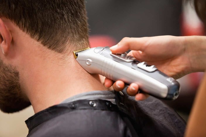 Man having a haircut with a hair clippers Man having a haircut with a hair clippers
