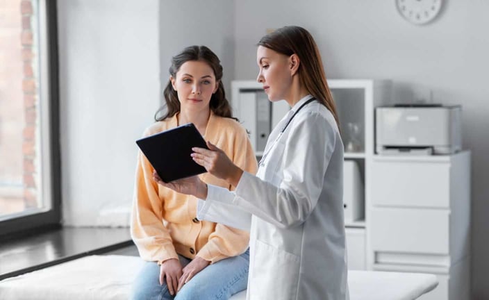 medicine, healthcare and people concept - female doctor with tablet pc computer talking to woman patient at hospital medicine, healthcare and people concept - female doctor with tablet pc computer talking to woman patient at hospital