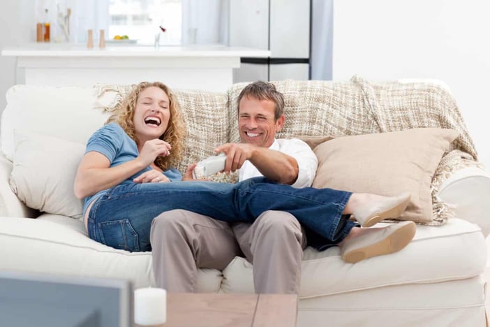 Lovers watching tv in the living room at home Lovers watching tv in the living room at home