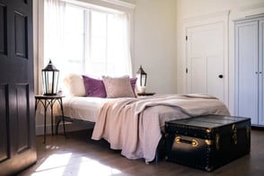 comfy looking bed in natural light-filled room