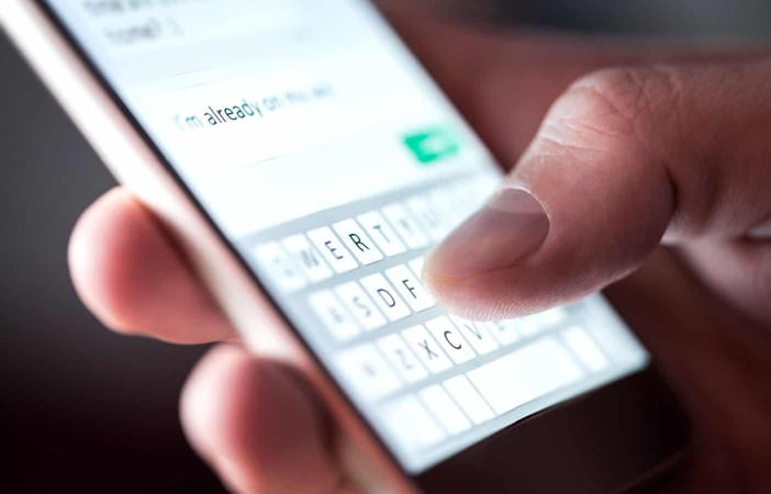 Hand texting on phone Hand texting on phone