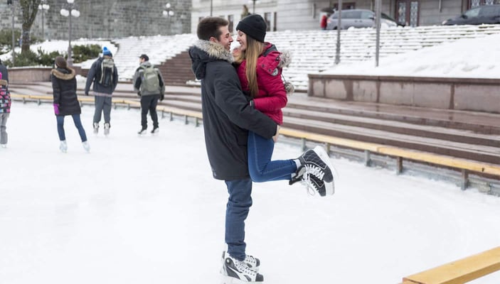 Happy couple ice skating outside Happy couple ice skating outside