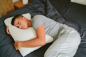 man holding pillow man holding pillow
