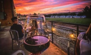 glass of wine in front of a sunset glass of wine in front of a sunset