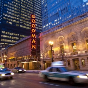 Outside view of the Goodman Theatre with cars whizzing by Outside view of the Goodman Theatre with cars whizzing by