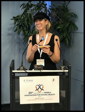 Woman holding award behind podium