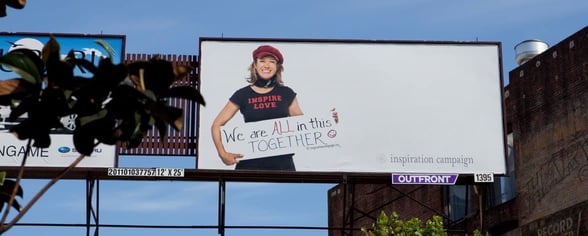 large billboard with woman holding sign on it