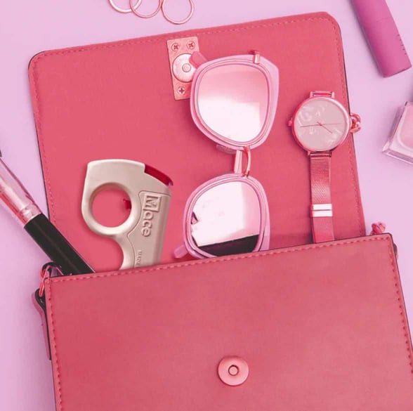 pepper spray, sunglasses, and lipstick in purse