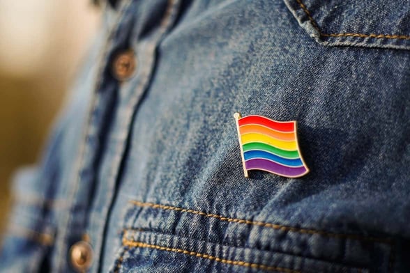 pride flag pin on jean jacket