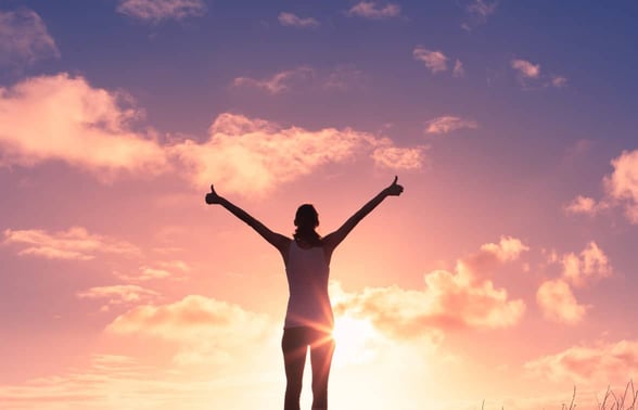 woman giving a big thumbs up to the sunset woman giving a big thumbs up to the sunset