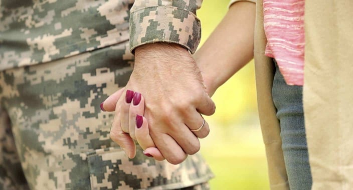 Photo of service member holding hands with a date Photo of service member holding hands with a date