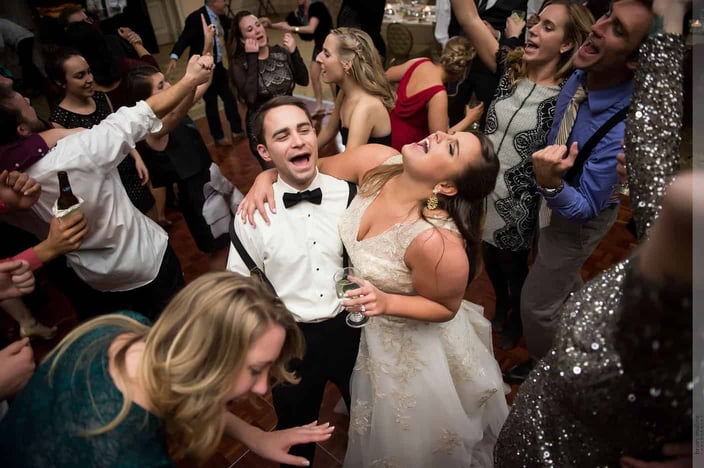 Bridge and groom dancing and singing on the dance floor at their wedding