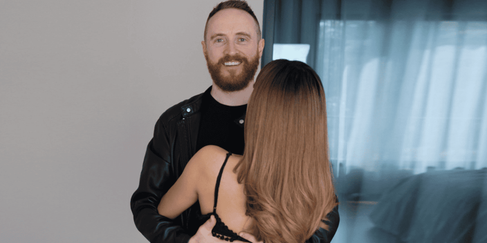 Dan Bacon holding his wife facing him