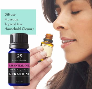 woman smelling geranium essential oil woman smelling geranium essential oil