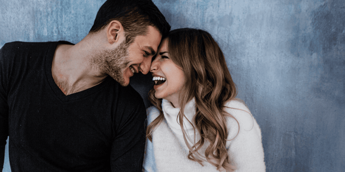 Young couple smiling and laughing faces pressed together Young couple smiling and laughing faces pressed together