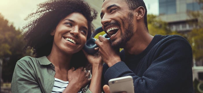 couple sharing headphones