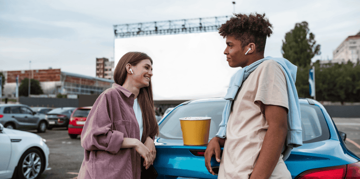 Young couple talking at drive-in theater Young couple talking at drive-in theater