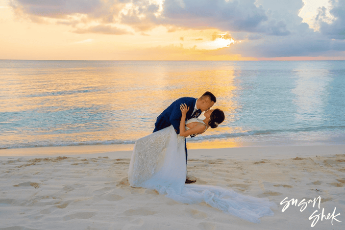 Susan Shek photograph of a couple kissing on a beach during sunset Susan Shek photograph of a couple kissing on a beach during sunset