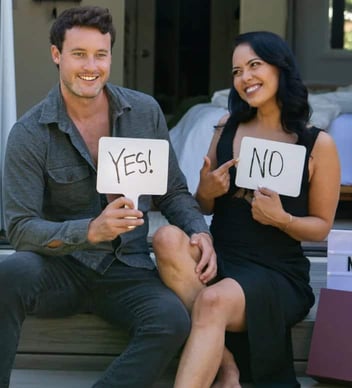 Man and woman holding yes and no signs