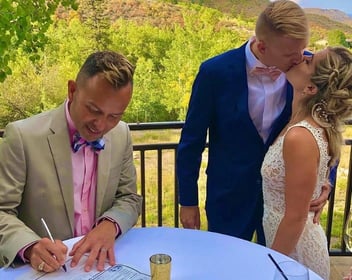 Tony with a couple at wedding