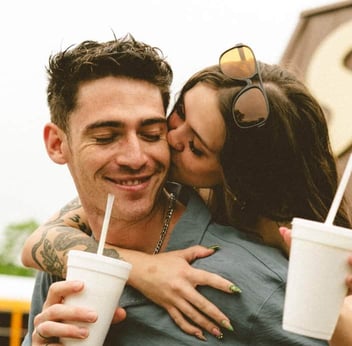 Girl kissing boyfriend on the cheek Girl kissing boyfriend on the cheek