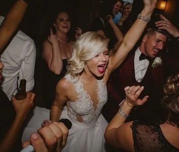 Bride singing and dancing at wedding