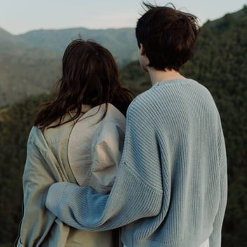 Inland Empire Couples Counseling young couple looking out at mountains from behind