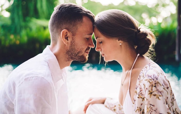 Young couple with eyes closed foreheads touching Young couple with eyes closed foreheads touching