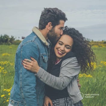 Photo of young couple hugging and smiling together
