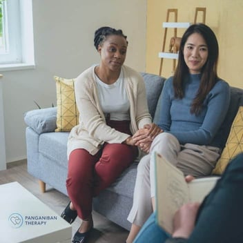 Photo of young female couple bonding in couples counseling