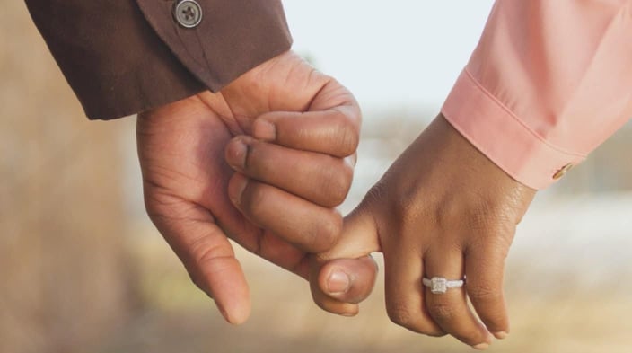 Photo of a married couple holding hands