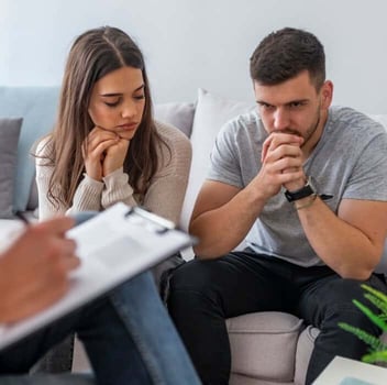 Photo of young couple sad in couples counseling 