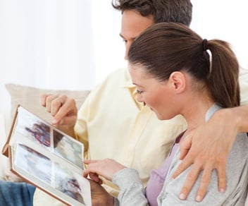 Young couple looking at pictures in a photo album