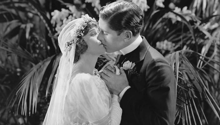 Photo of a 1930s couple kissing on their wedding day