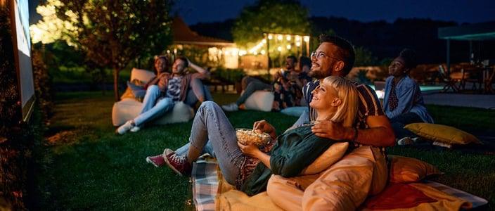 Photo of couples at an outdoor movie night