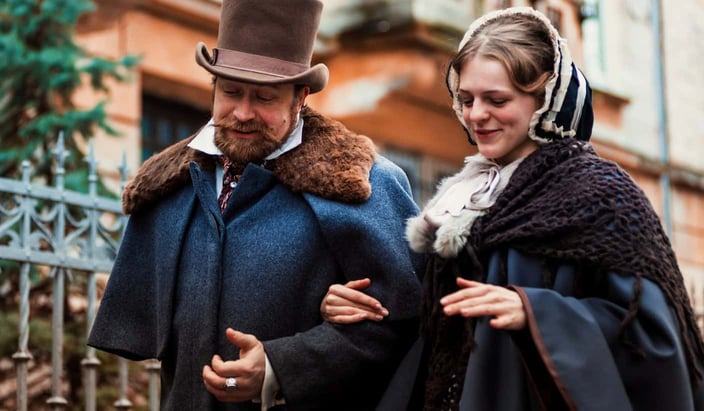 Stock photo of a couple walking arm in arm dressed in Victorian clothing