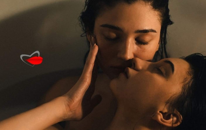 Photo of two women kissing and cuddling in a bathtub Photo of two women kissing and cuddling in a bathtub
